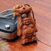 Lucky amulet - <br>Wood carved Happy Buddha holding up an ingot Key chain